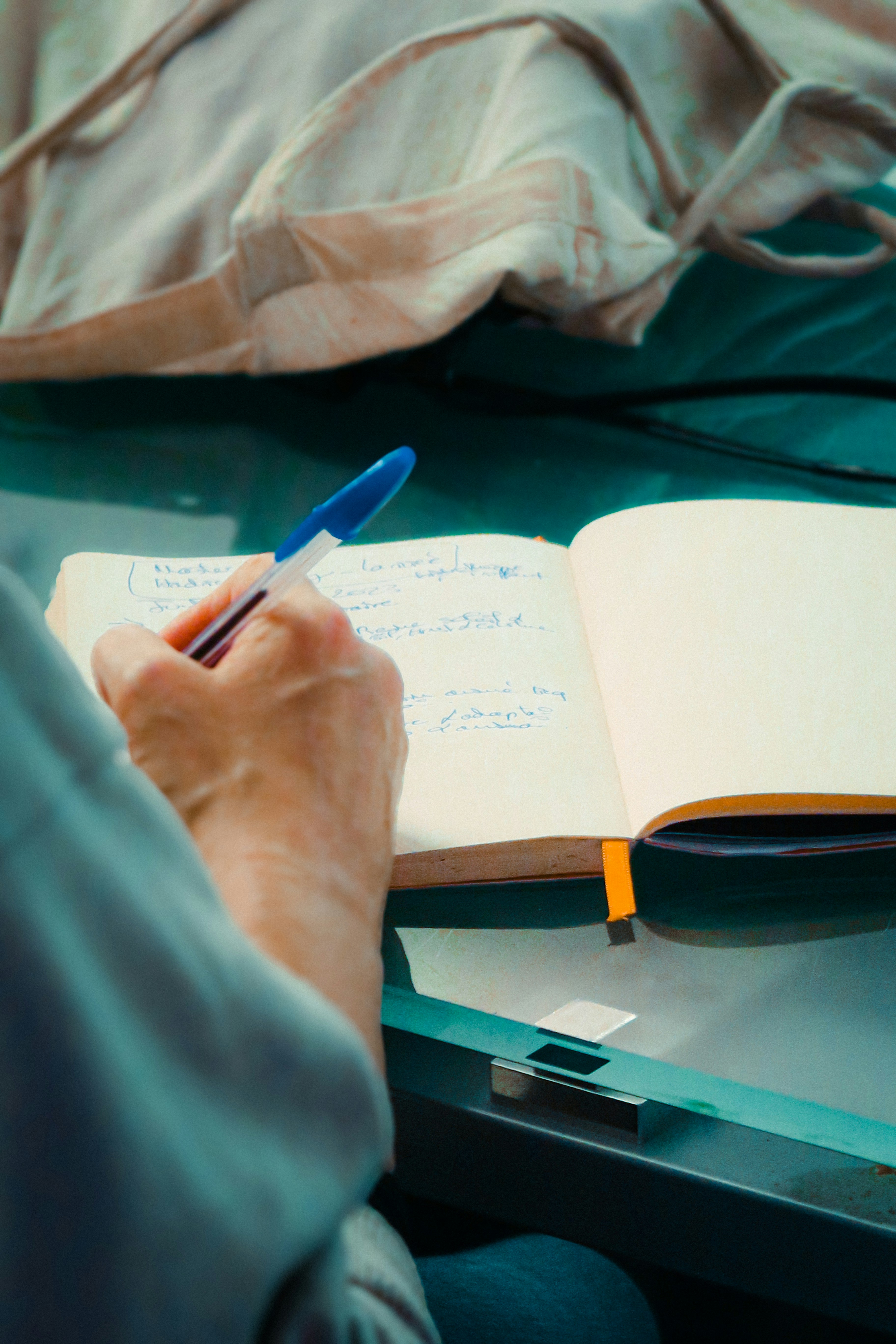 Person writing in a journal — a quiet moment of reflection